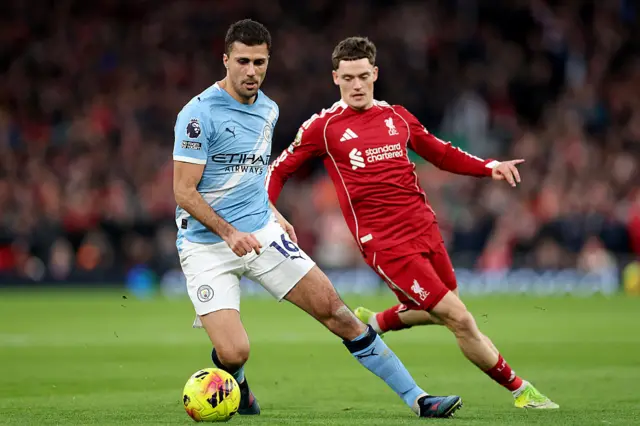 Rodri of Manchester City is put under pressure by Florian Wirtz of Liverpool during the Premier League match between Liverpool and Manchester City at Anfield on February 08, 2026 in Liverpool, England.