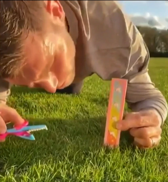 James Milner cutting his lawn with scissors