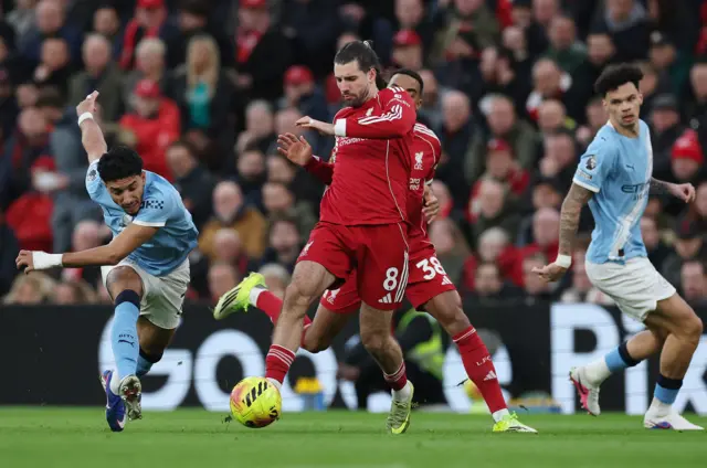 Manchester City's Omar Marmoush in action with Liverpool's Dominik Szoboszlai.