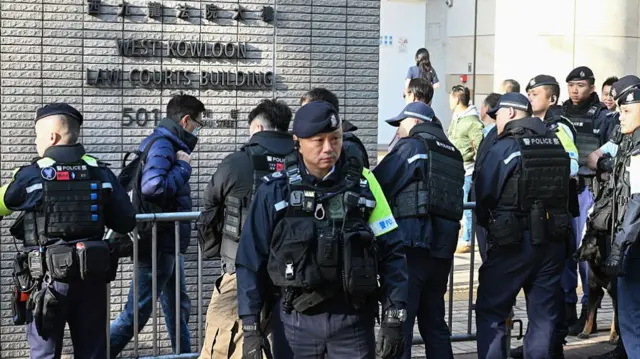 Police wait outside the court building