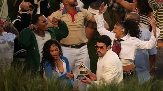 Bad Bunny seen holding his Grammy Award during the half-time show at the Super Bowl on Sunday