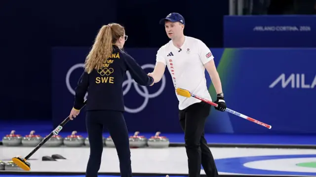 Isabella Wrana and Bruce Mouat shake hands