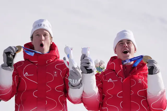 Gold medallists Switzerland's Tanguy Nef (L) and Switzerland's Franjo von Allmen celebrate gold