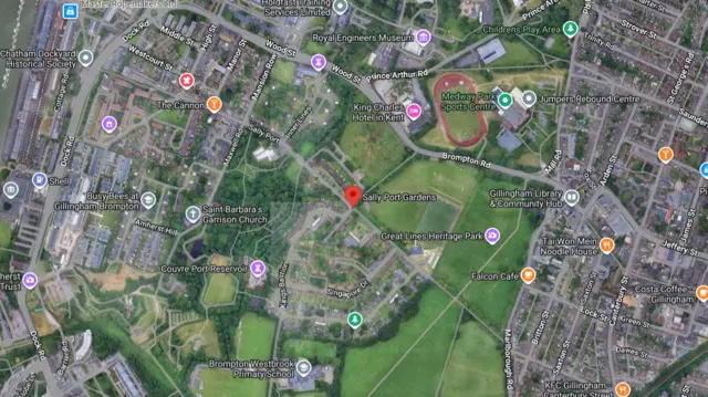 A satellite image of a green area within a town.