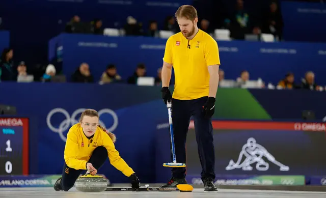 Sweden's Isabella Wranaa and Sweden's Rasmus Wrana competes in the curling mixed doubles round robin semi-final between Great Britain and Sweden
