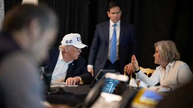 US President Donald Trump speaks with White House Chief of Staff Susie Wiles and Secretary of State Marco Rubio during military operations in Iran, at Trump's Mar-a-Lago resort in Palm Beach, Florida