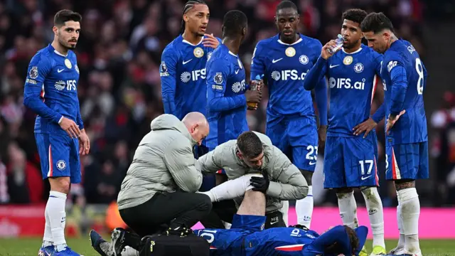 Cole Palmer of Chelsea receives medical treatment