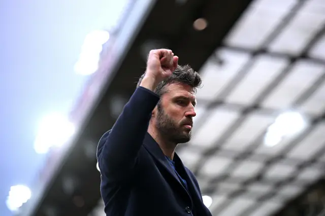 Carrick gestures to the fans