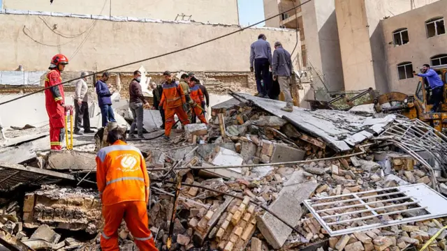 Iranian rescuers search through the rubble of a collapsed building following an air strike on one of Tehran's neighbourhoods. Photo: 28 February 2026