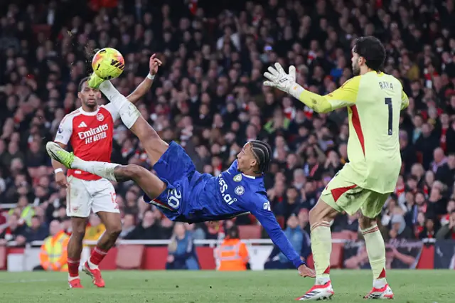 Joao Pedro of Chelsea lobs David Raya of Arsenal with an overhead