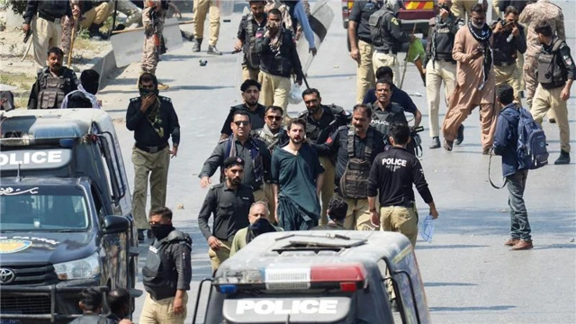 Security forces detain a protester outside the U.S. Consulate General, following news of U.S. and Israeli strikes on Iran that killed Iran's Supreme Leader Ayatollah Ali Khamenei, in Karachi, Pakistan March 1, 2026.