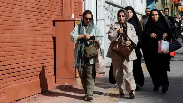Women are seen walking to try find a shelter after a blast in Tehran. Photo: 28 February 2026