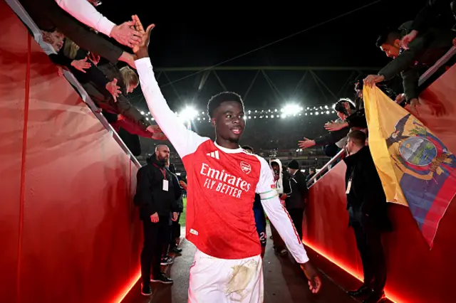 Saka celebrates as he walks down the tunnel