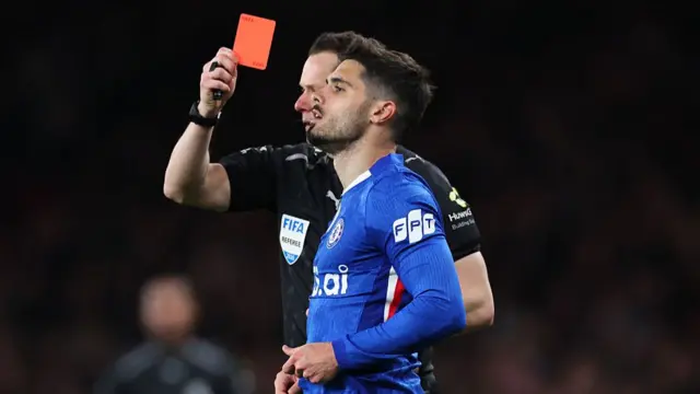 Pedro Neto of Chelsea is shown a red card