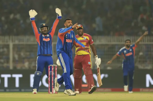 Varun Chakravarthy of India unsuccessfully appeals for the LBW of Rovman Powell of West Indies during the ICC Men's T20 World Cup India & Sri Lanka 2026 Super 8 match between India and West Indies at Eden Gardens