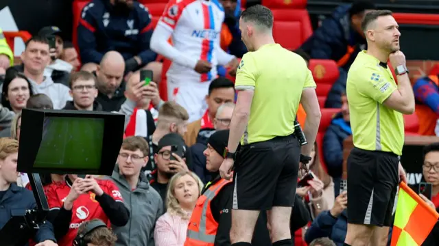 Referee Chris Kavanagh views VAR Monitor