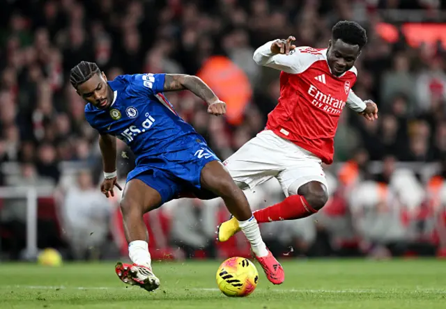 Bukayo Saka of Arsenal is fouled by Jorrel Hato of Chelsea