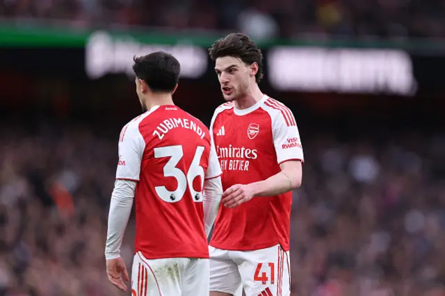Declan Rice of Arsenal speaks to Martin Zubimendi
