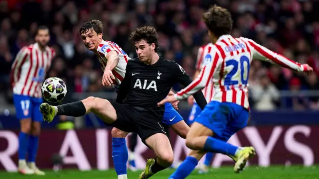 Robin Le Normand of Atletico de Madrid battles for the ball with Archie Gray of Tottenham Hotspur