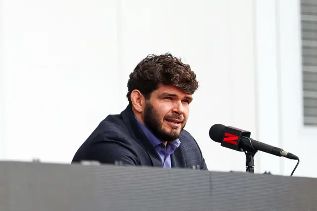 Philipe Lins speaks on a microphone