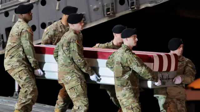 Members of the military carry the transfer case during a dignified transfer of the remains of U.S. Army Sgt. Benjamin Pennington, who died on March 8 from injuries sustained during a March 1 attack at Prince Sultan Air Base in Saudi Arabia, at Dover Air Force Base in Dover, Delaware, U.S., March 9