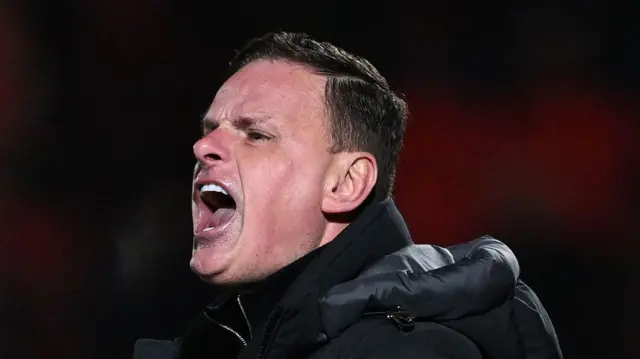 Leyton Orient boss Richie Wellens shouting at his team from the touchline.