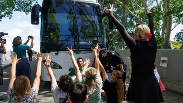 Proteters block the path of a bus in Australia in support of the Iranian women's football team