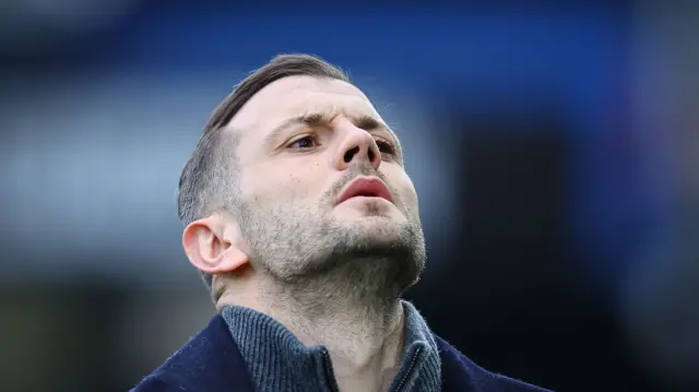 Luton Town boss Jack Wilshere reacts by raising his head upwards in frustration.