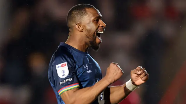 Tendayi Darikwa of Lincoln City celebrates at full time