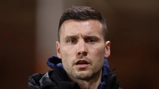 Walsall boss Mat Sadler looking on from the touchline with his mouth ajar.