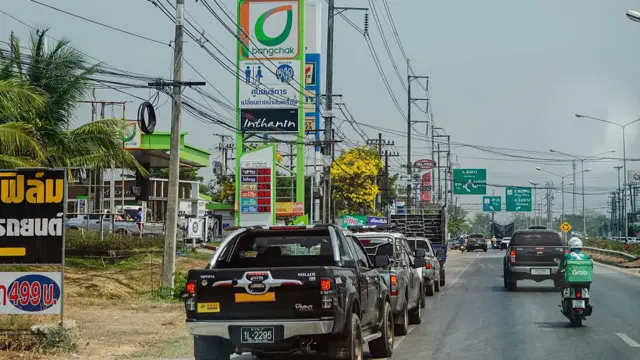 Long queues of vehicles line the road in Mae Sot, Thailand, queuing for petrol