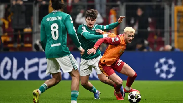 ) Baris Alper Yilmaz of Galatasaray A.S. is challenged by Milos Kerkez of Liverpool