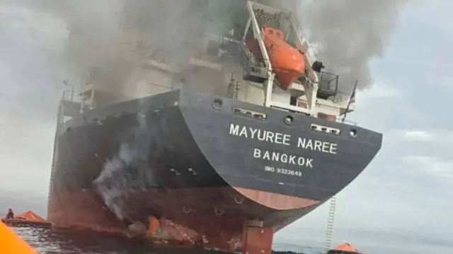he Thailand-flagged cargo ship Mayuree Naree engulfed in black smoke in the Strait of Hormuz, March 11, 2026