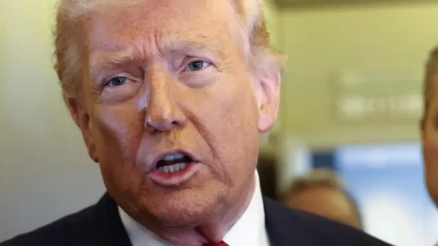 A close-cropped photo of Donald Trump speaking.