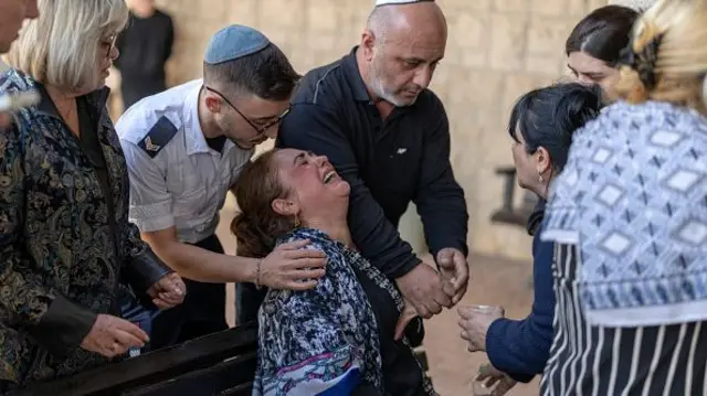 Relatives attend the funeral of a man killed by an Iranian ballistic missile on the Israeli city of Yehud