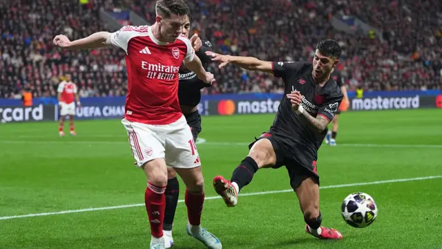Viktor Gyoekeres of Arsenal is challenged by Exequiel Palacios of Bayer 04 Leverkusen