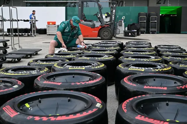 An Aston Martin team paper stands over tyres laid out on the floor in Shanghai