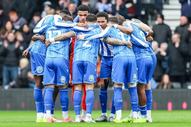Sheffield Wednesday players stand in a huddle