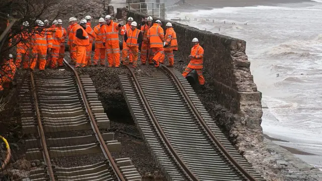 : Railway workers inspect the main Exeter to Plymouth railway line that was closed due to parts of it being washed away by the sea at Dawlish on February 5, 2014. in