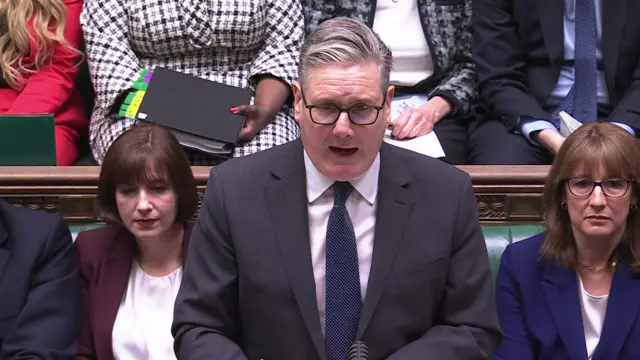 Keir Starmer speaking to House of Commons in a grey suit