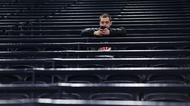 A Tottenham fan sat by himself inside the Tottenham Hotspur Stadium