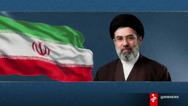 Graphic showing new Iranian supreme leader next to Iranian flag which was displayed as the statement was read out.