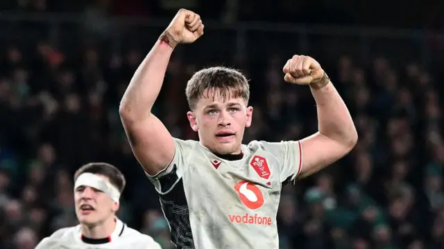 Alex Mann raises his arms