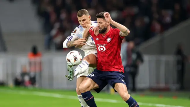 : Lucas Digne of Aston Villa battles for possession with Olivier Giroud