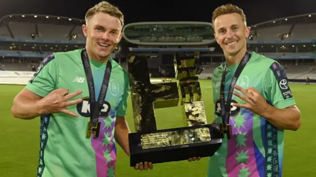 Sam Curran (L) and Tom Curran of Oval Invincibles hold the trophy