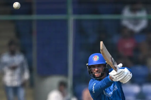 Afghanistan's Azmatullah Omarzai plays a shot