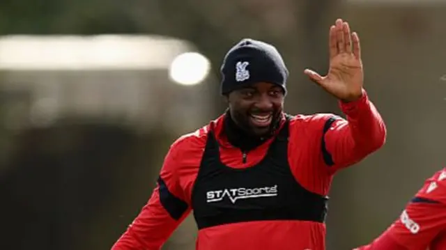 Jean-Philippe Mateta waves his hand in Palace training