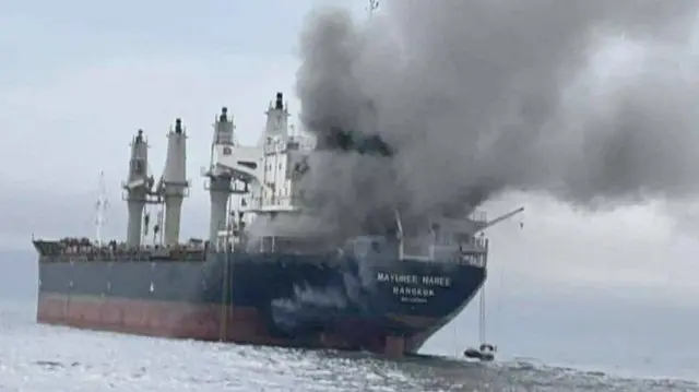 The Thailand-flagged cargo ship Mayuree Naree engulfed in black smoke in the Strait of Hormuz