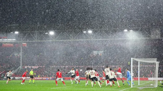 General view of play inside the stadium as rain pours