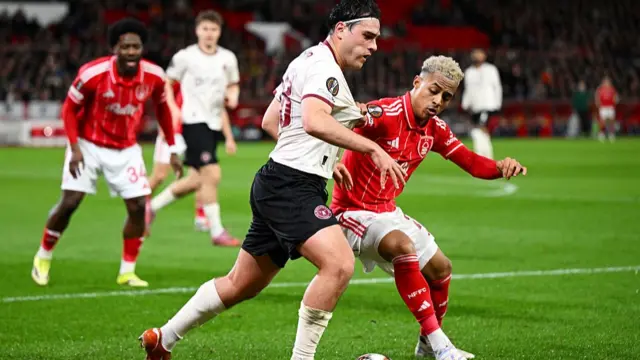 Aral Simsir of FC Midtjylland is challenged by Omari Hutchinson of Nottingham Forest d